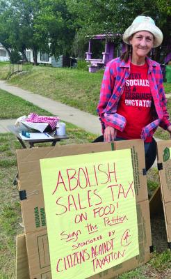 Mangum resident Misty Peñuelas at her grocery tax petition table on S. Pennsylvania. Mike Bush | Mangum Star