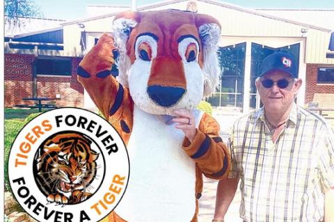 Mangum Alumni President L.D. Ormand, Class of ’82, and the original Mangum Tiger Mascot are at Mangum High School getting ready for this weekend’s 114th Alumni celebration. Be sure and take in all of the events happening including the parade on Saturday where the “OG” Mangum Tiger Mascot Norbert Alsup will be tossing out bags of snack cracker treats.