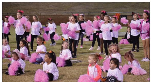 Mini Cheer kids perform at Pink Out game