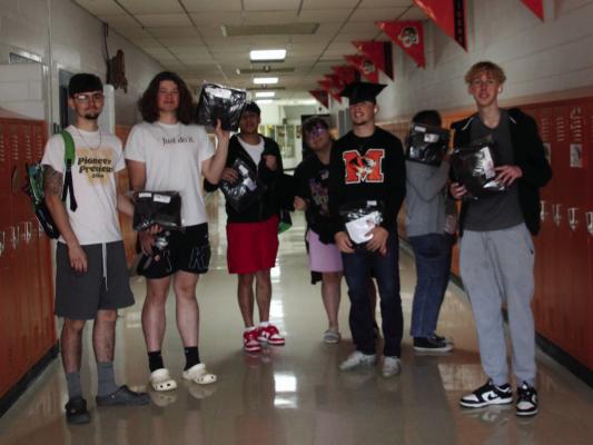 Seniors are saying “YES” to their caps &amp; gowns. They are (l-r) Hayden Stevens, Mason Dreyer, Jimmy Estraca, Taylor Wilmes, Aidan Warner, Rosey Martinez (hiding), and Koy Giddens.